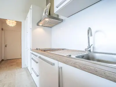 a kitchen with white cabinets and a sink at Apartment Cannes Parc-2 by Interhome in Cannes