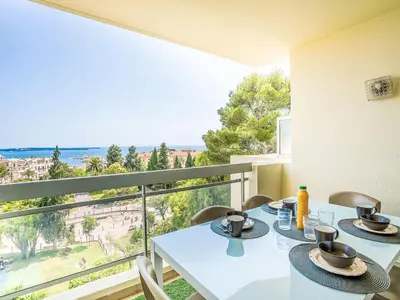 a dining room with a view of the ocean at Apartment Cannes Parc-2 by Interhome in Cannes