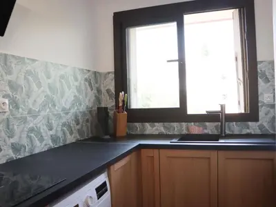 a kitchen with a sink and a window at Apartment les Gemeaux by Interhome in Le Cannet
