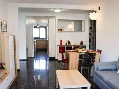 a living room with a couch and a table at Apartment les Gemeaux by Interhome in Le Cannet