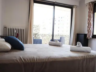a bed with two towels on it with a window at Apartment les Gemeaux by Interhome in Le Cannet