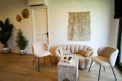 a living room with a couch and two chairs at Bali à Cannes in Cannes