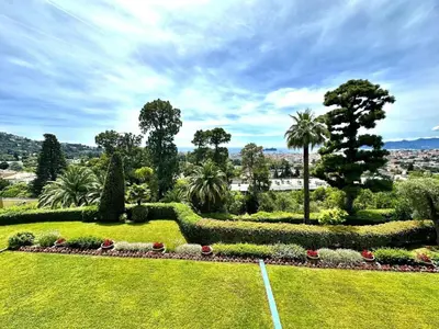 a garden with bushes and flowers in a park at appartement cannes in Cannes