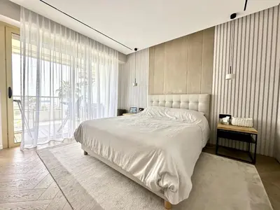 a bedroom with a large bed and a large window at appartement cannes in Cannes