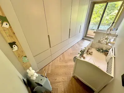 a baby crib in a room with a window at appartement cannes in Cannes