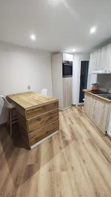 a kitchen with a wooden desk in a room at Cannes Fleurs de Provence - proche centre-ville in Cannes