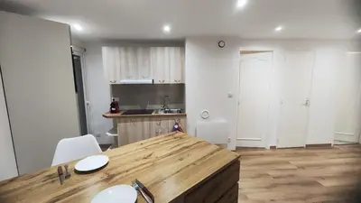 a kitchen with a wooden counter top in a room at Cannes Fleurs de Provence - proche centre-ville in Cannes