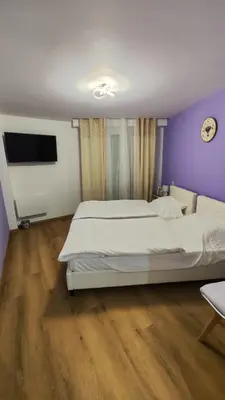 a bedroom with two beds and a flat screen tv at Cannes Fleurs de Provence - proche centre-ville in Cannes