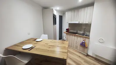 a kitchen with a wooden counter top in a room at Cannes Fleurs de Provence - proche centre-ville in Cannes