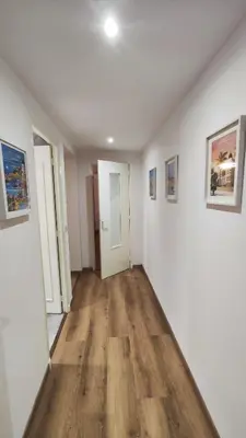 an empty room with white walls and wooden floors at Cannes Fleurs de Provence - proche centre-ville in Cannes