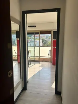 an open door to a room with a view of a balcony at Le FRAGONNARD in Cannes