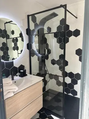 a bathroom with a shower and a white sink at Le FRAGONNARD in Cannes