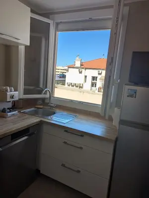 a kitchen with a sink and a large window at Charming 2-room apartment in Cannes in Cannes