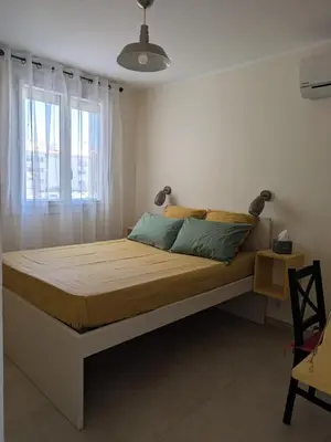 a bedroom with a large bed with a window at Charming 2-room apartment in Cannes in Cannes