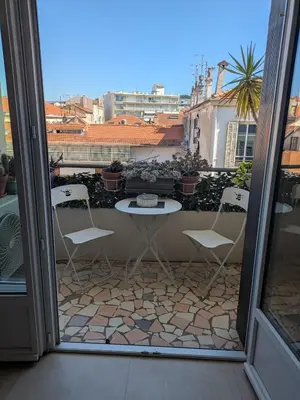 a patio with a table and chairs on a balcony at Charming 2-room apartment in Cannes in Cannes