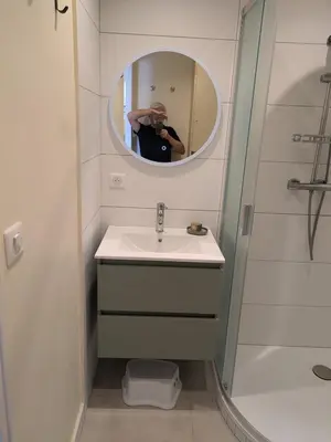 a person taking a picture of a bathroom with a sink at Charming 2-room apartment in Cannes in Cannes