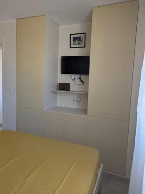 a bedroom with a bed and a tv on a wall at Charming 2-room apartment in Cannes in Cannes