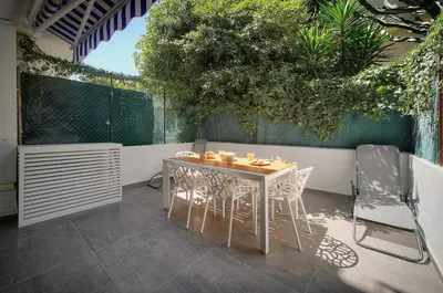 a table and chairs sitting on a patio at Modern 3BR with Patio, Walk to Beach and Croisette in Cannes