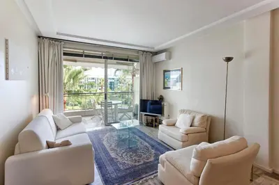 a living room with two white couches and a tv at REF 1233 - Cannes Croisette - Apartment for rent in Cannes