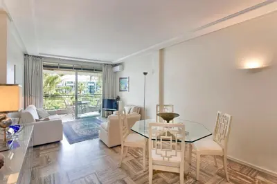 a living room with a glass table and chairs at REF 1233 - Cannes Croisette - Apartment for rent in Cannes