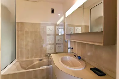 a bathroom with a sink and a tub and a mirror at REF 1233 - Cannes Croisette - Apartment for rent in Cannes