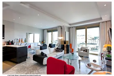 a living room with a couch and a table at REF 843 - Cannes Croisette - Sea view apartment for rent in Cannes