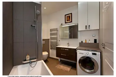 a bathroom with a washing machine and a sink at REF 843 - Cannes Croisette - Sea view apartment for rent in Cannes