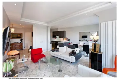 a living room with a couch and a red chair at REF 843 - Cannes Croisette - Sea view apartment for rent in Cannes