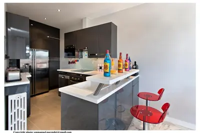 a kitchen with a counter with drinks on it at REF 843 - Cannes Croisette - Sea view apartment for rent in Cannes