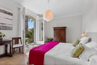 a bedroom with a bed and a desk and a window at REF 1223 - Cannes - Villa for rent in Vallauris