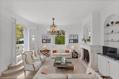 a living room with white furniture and a fireplace at REF 1223 - Cannes - Villa for rent in Vallauris