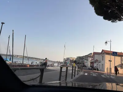 a dining room table with chairs and a blue couch at T2 refait à neuf à 50m de la plage Moure Rouge in Cannes