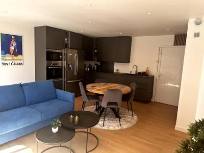 a living room with a blue couch and a table at T2 refait à neuf à 50m de la plage Moure Rouge in Cannes