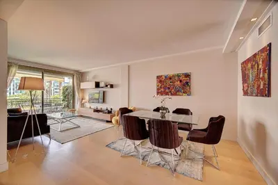 a dining room with a table and chairs in a living room at REF 1434 - Cannes Croisette - Sea view apartment for rent in Cannes