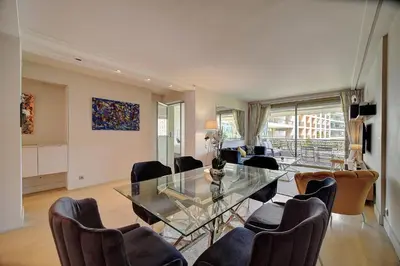 a living room with a glass table and chairs at REF 1434 - Cannes Croisette - Sea view apartment for rent in Cannes