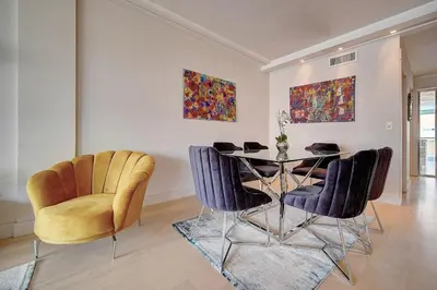 a dining room with a table and chairs at REF 1434 - Cannes Croisette - Sea view apartment for rent in Cannes