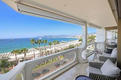 a room with a view of a beach and the ocean at REF 1991 - Cannes Croisette - Sea view apartment for rent in Cannes
