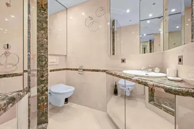 a bathroom with a sink and a toilet and a mirror at REF 1991 - Cannes Croisette - Sea view apartment for rent in Cannes