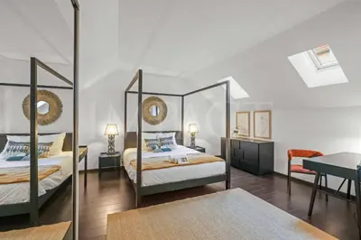 a bedroom with two beds and a mirror at REF 1994 - Cannes Croisette - 5 mins to the Palais in Cannes