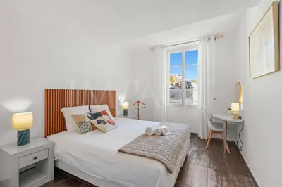 a bedroom with a bed with a desk and a window at REF 1994 - Cannes Croisette - 5 mins to the Palais in Cannes