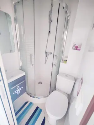 a white bathroom with a shower and a toilet at Cannes Croisette Terrasse Vue sur la mer et la ville 5 mn de la plage in Cannes