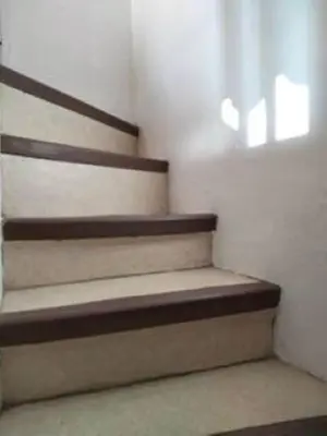a set of stairs in a room with a window at Cannes Croisette Terrasse Vue sur la mer et la ville 5 mn de la plage in Cannes
