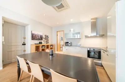 a kitchen with a black table and chairs in it at Appartement Cannes, Majestic in Cannes