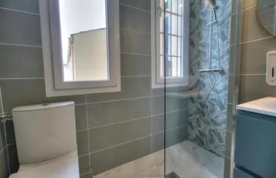 a bathroom with a toilet and a glass shower at Cannes centre rue d'antibes et palais in Cannes