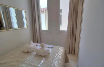 a bedroom with two swans sitting on a bed at Cannes centre rue d'antibes et palais in Cannes