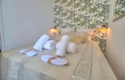 a bed with white pillows on top of it at Cannes centre rue d'antibes et palais in Cannes