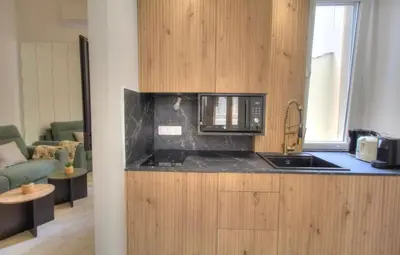 a kitchen with a sink and a microwave at Cannes centre rue d'antibes et palais in Cannes