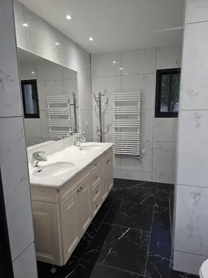 a bathroom with a sink and a large mirror at 1-Bedroom guesthouse with pool access in Cannes