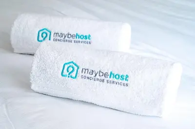 a pile of white towels sitting on a bed at B020- Elegante et lumineux a deux pas plages et centre in Cannes