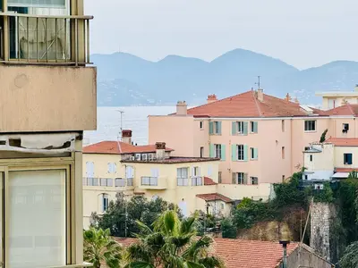 a group of buildings with mountains in the background at B020- Elegante et lumineux a deux pas plages et centre in Cannes